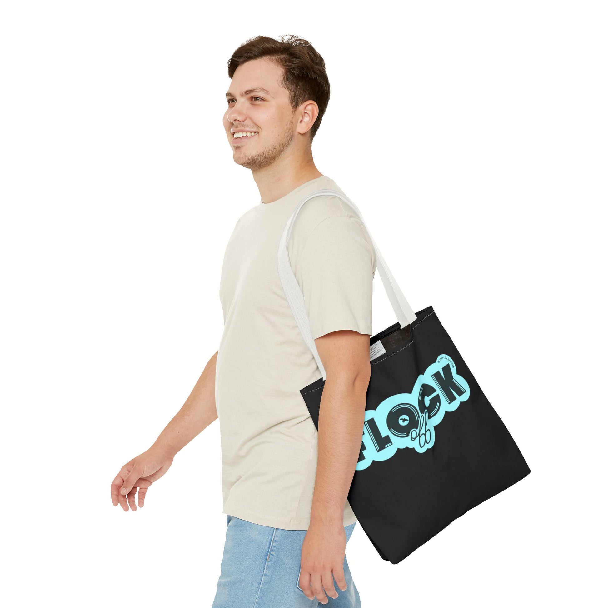 Black canvas tote bag with the playful 'Flock Off' design, carried by a person walking outdoors. Perfect for making a bold and stylish statement on the go.