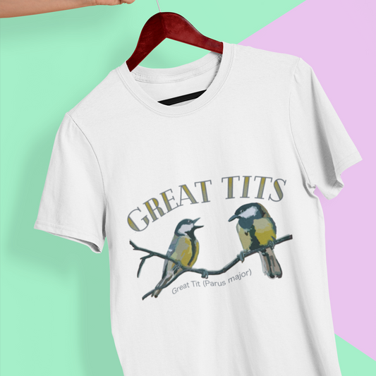 Vintage white t-shirt featuring a humorous 'Great Tits' birding design with detailed bird illustrations, displayed flat on a colorful background. Perfect for bird watchers and nature enthusiasts.