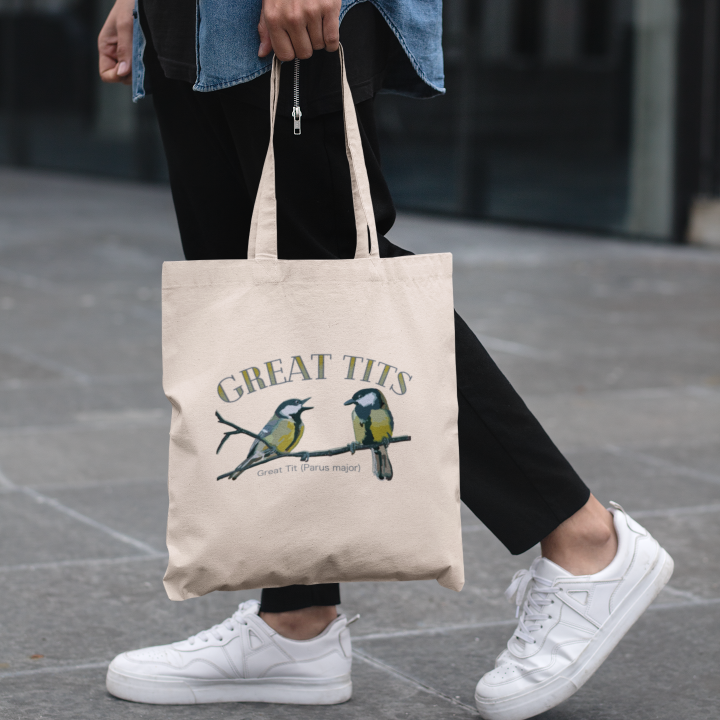 Canvas tote bag with the 'Great Tits' design being carried, perfect for everyday use and bird lovers.