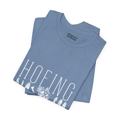 Funny 'Hoeing Ain't Easy' gardening t-shirt in slate blue, folded. Perfect for gardeners who love humor.