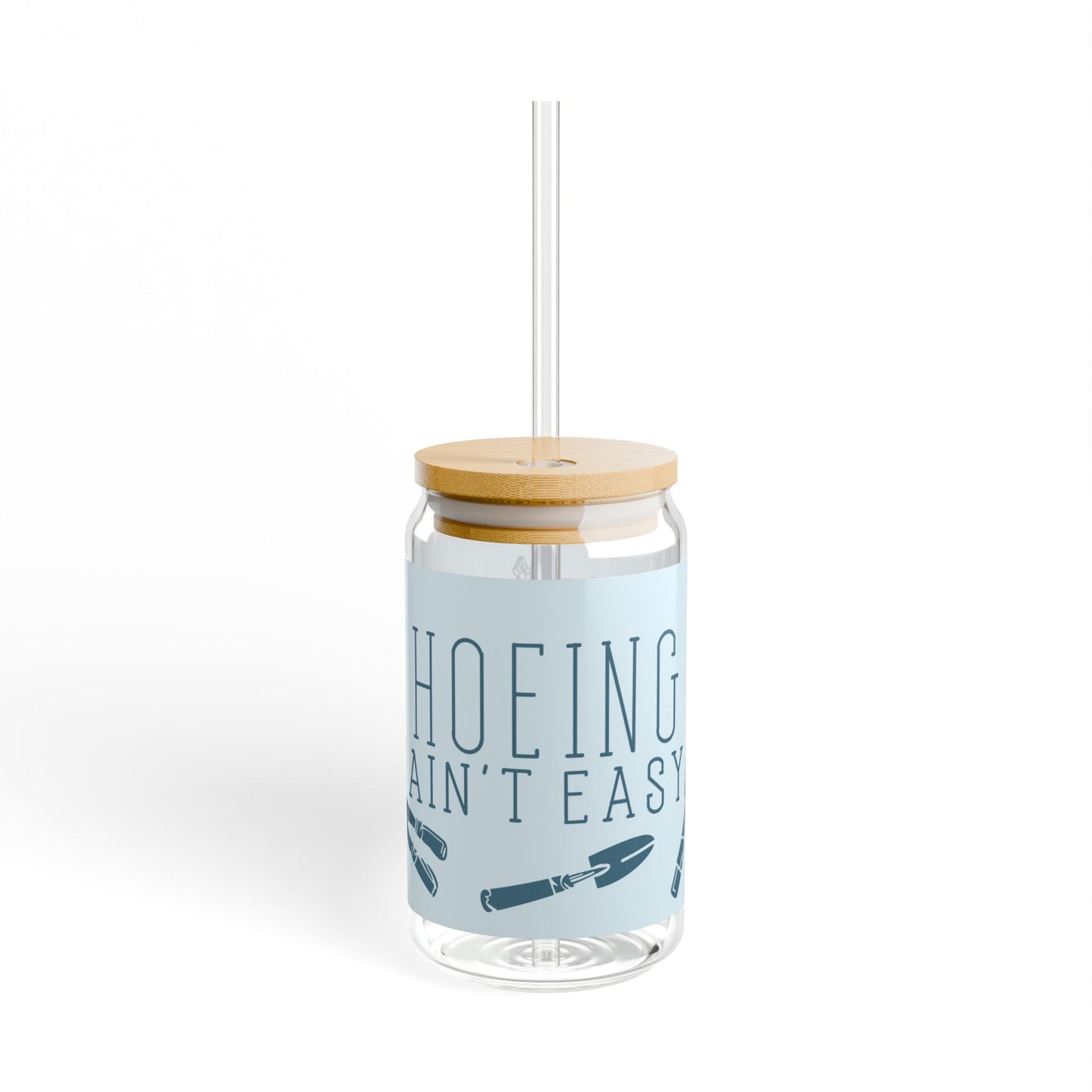 Second side view of the 'Hoeing Ain't Easy' glass tumbler, highlighting additional details of the playful gardening design, displayed on a white background.