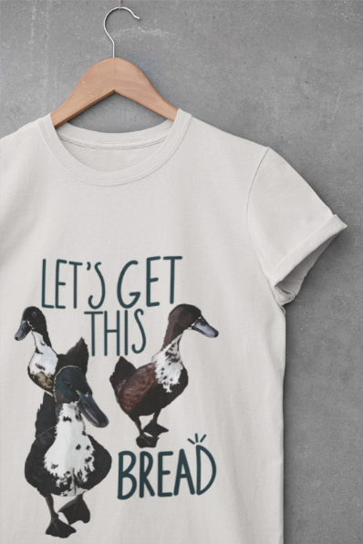 Close-up view of the 'Let’s Get This Bread' t-shirt design, highlighting the intricate duck illustration and bold, playful text on soft fabric.